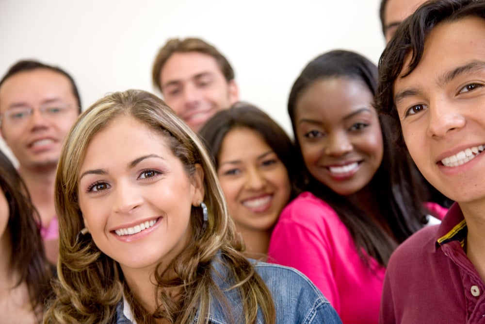 Multi-ethnic group of university students smiling in a classroom